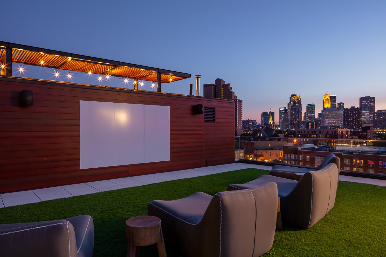 Outdoor projection screen with lounge seating on turf